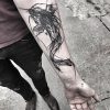 Black and white carp tattoo on arm - meanings