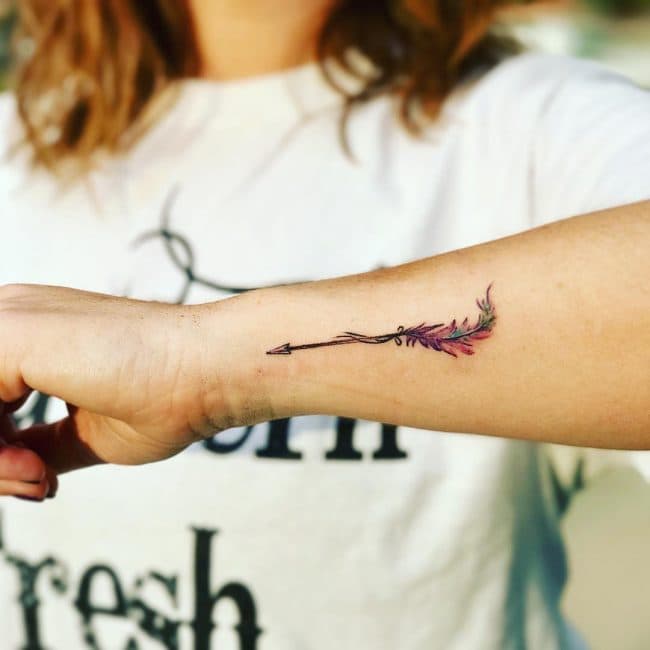 Tiny black arrow tattoo on the wrist - Tattoogrid.net