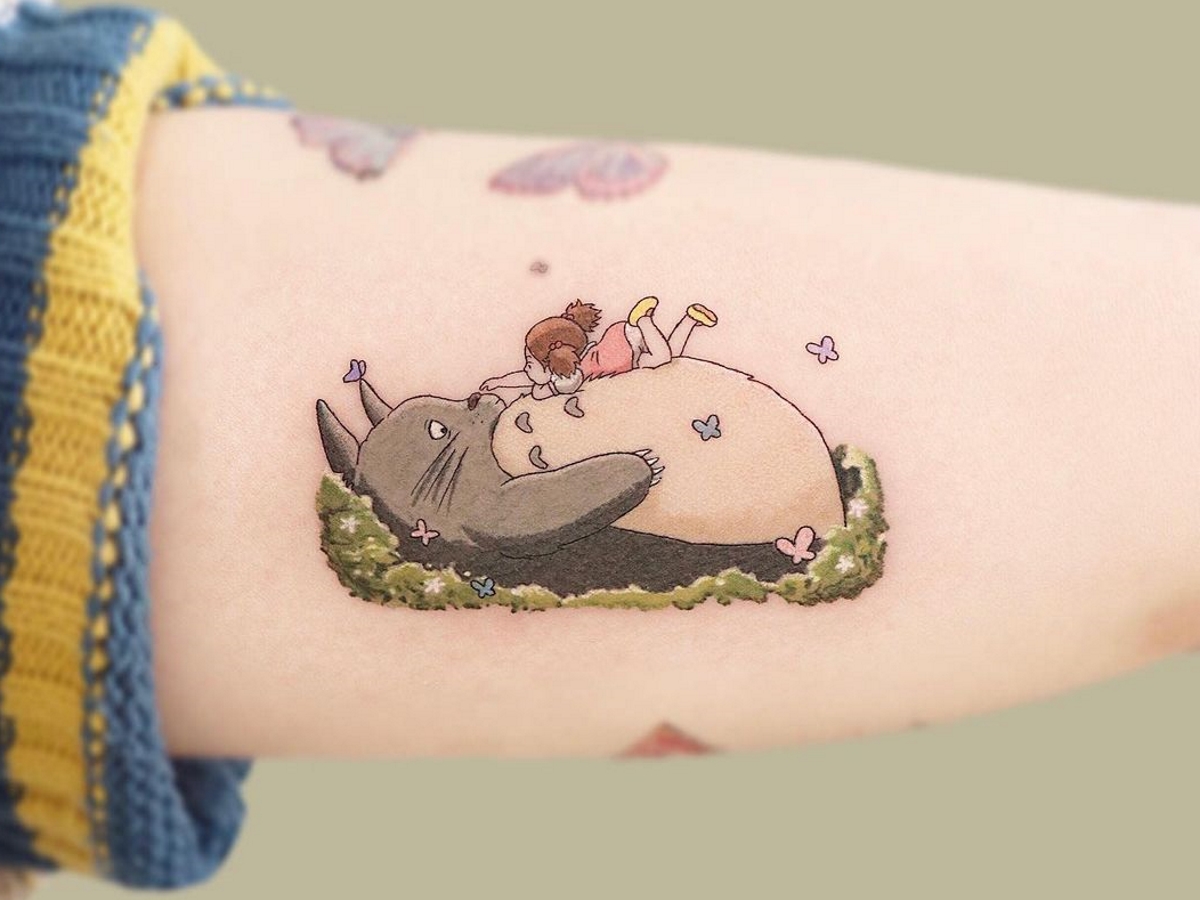 Totoro tattoo on the left thigh