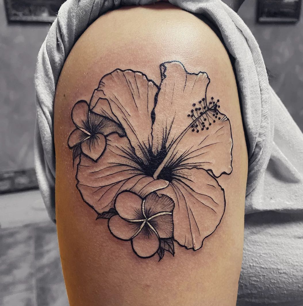 Hibiscus flower tattooed on the shoulder blade